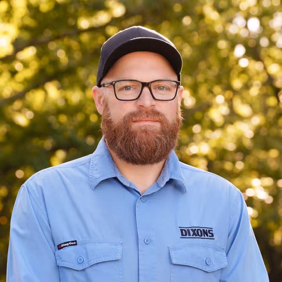 Bearded man in glasses and cap outdoors